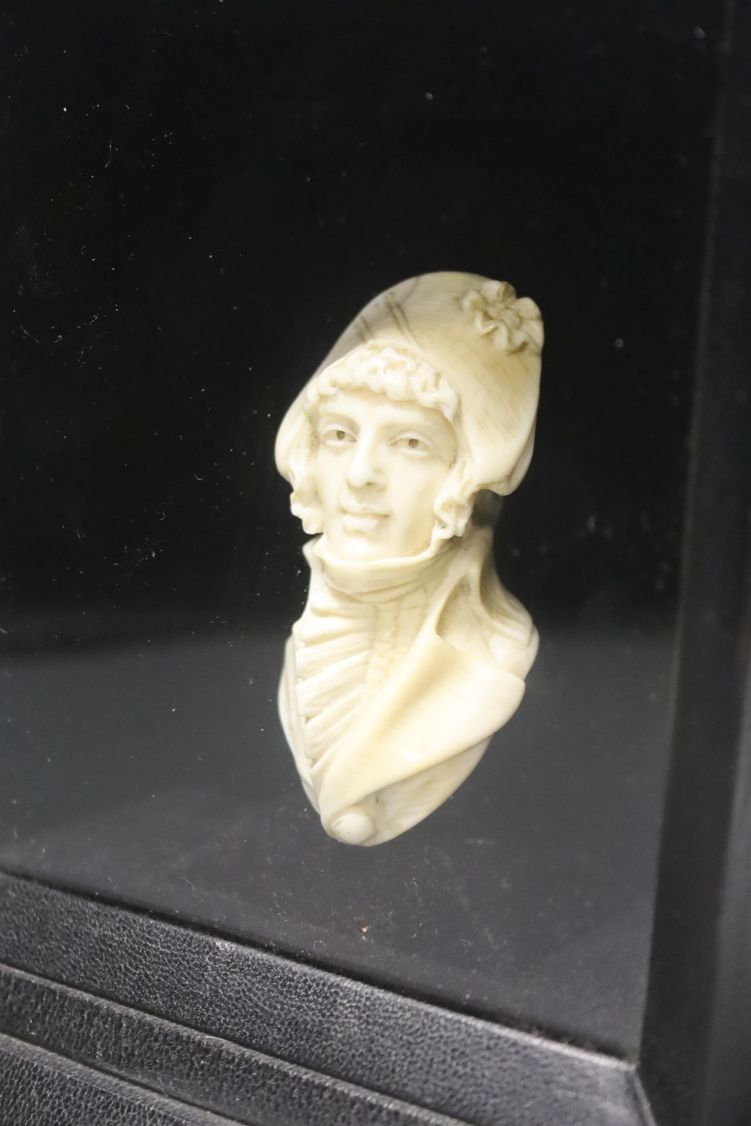 A 19th century carved bust of a French military gentleman, cased, height 17cm, width 16cm